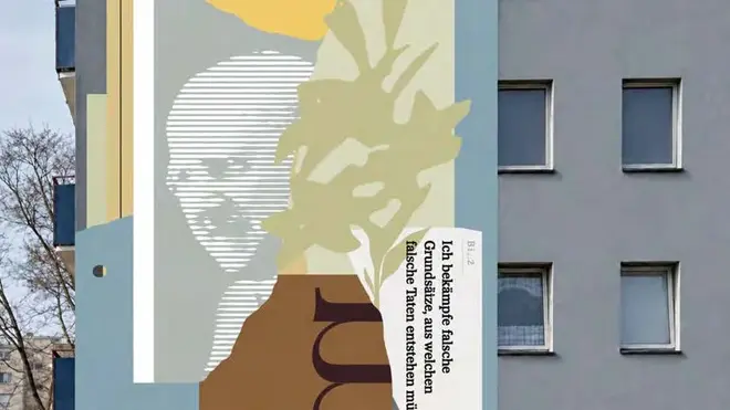 Foto eines Wandgemäldes von Bernhard Lichtenberg und einem Zitat an einer Hauswand